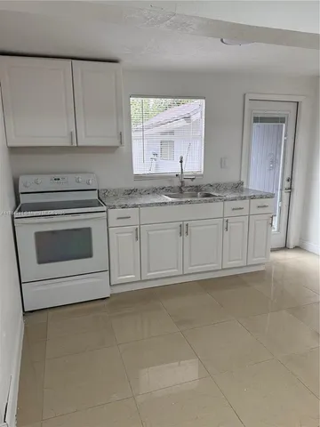 a kitchen with stainless steel appliances granite countertop a sink and a stove top oven