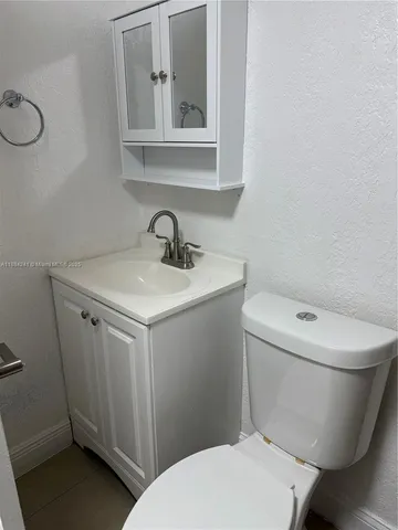 a white toilet sitting next to a bathroom sink