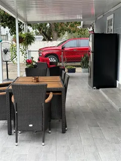 a view of a patio with table and chairs potted plants
