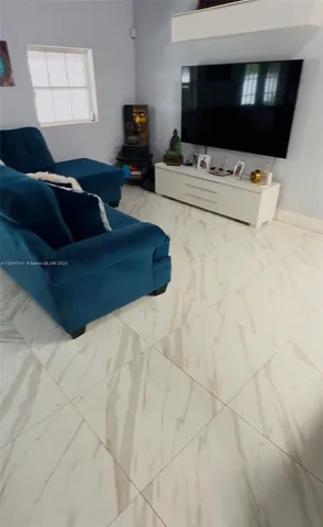 a living room with a couch and a flat screen tv