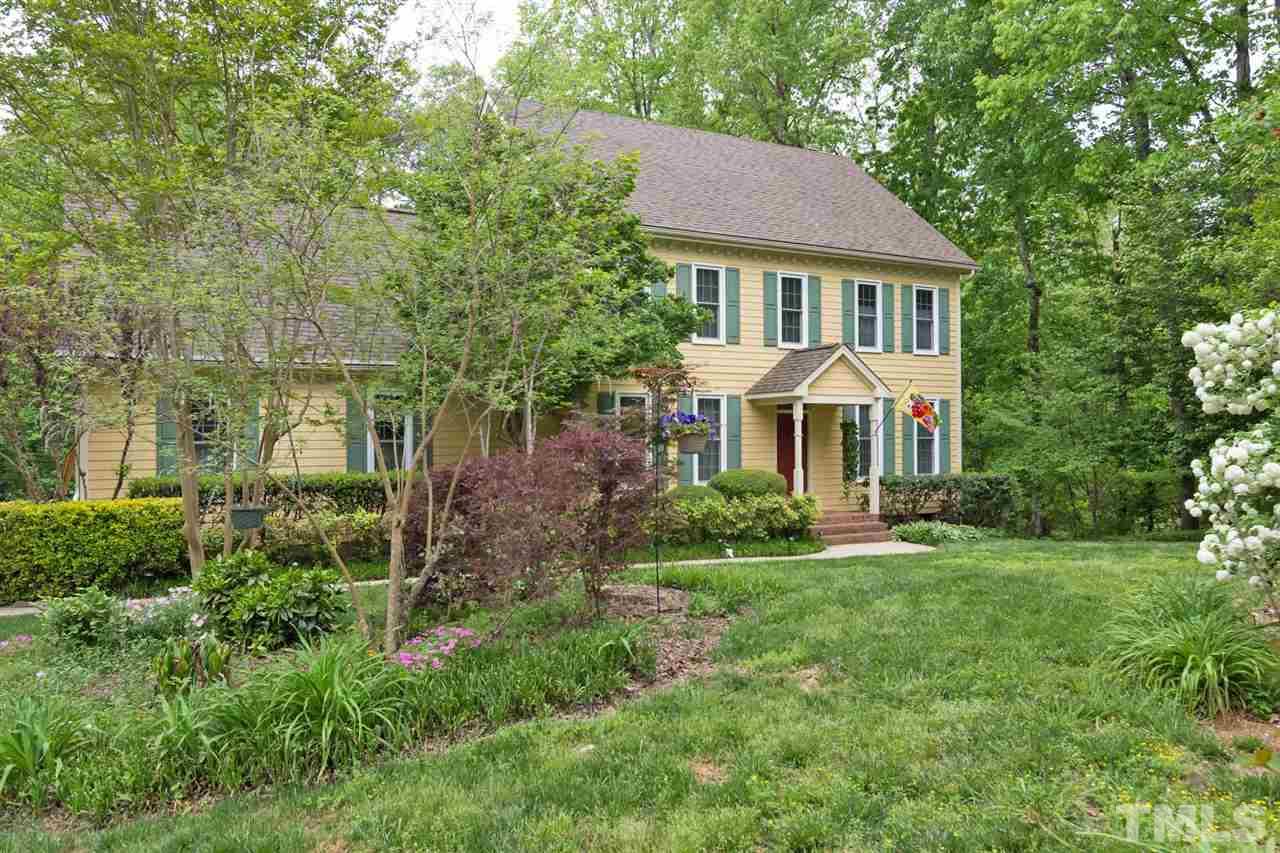 6104 Hampton Ridge Road Raleigh, NC 27603 - Photo 2 of 23 a front view of a house with a yard and trees