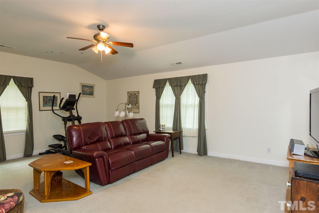 6104 Hampton Ridge Road Raleigh, NC 27603 - Photo 13 of 23 a living room with furniture and a chandelier