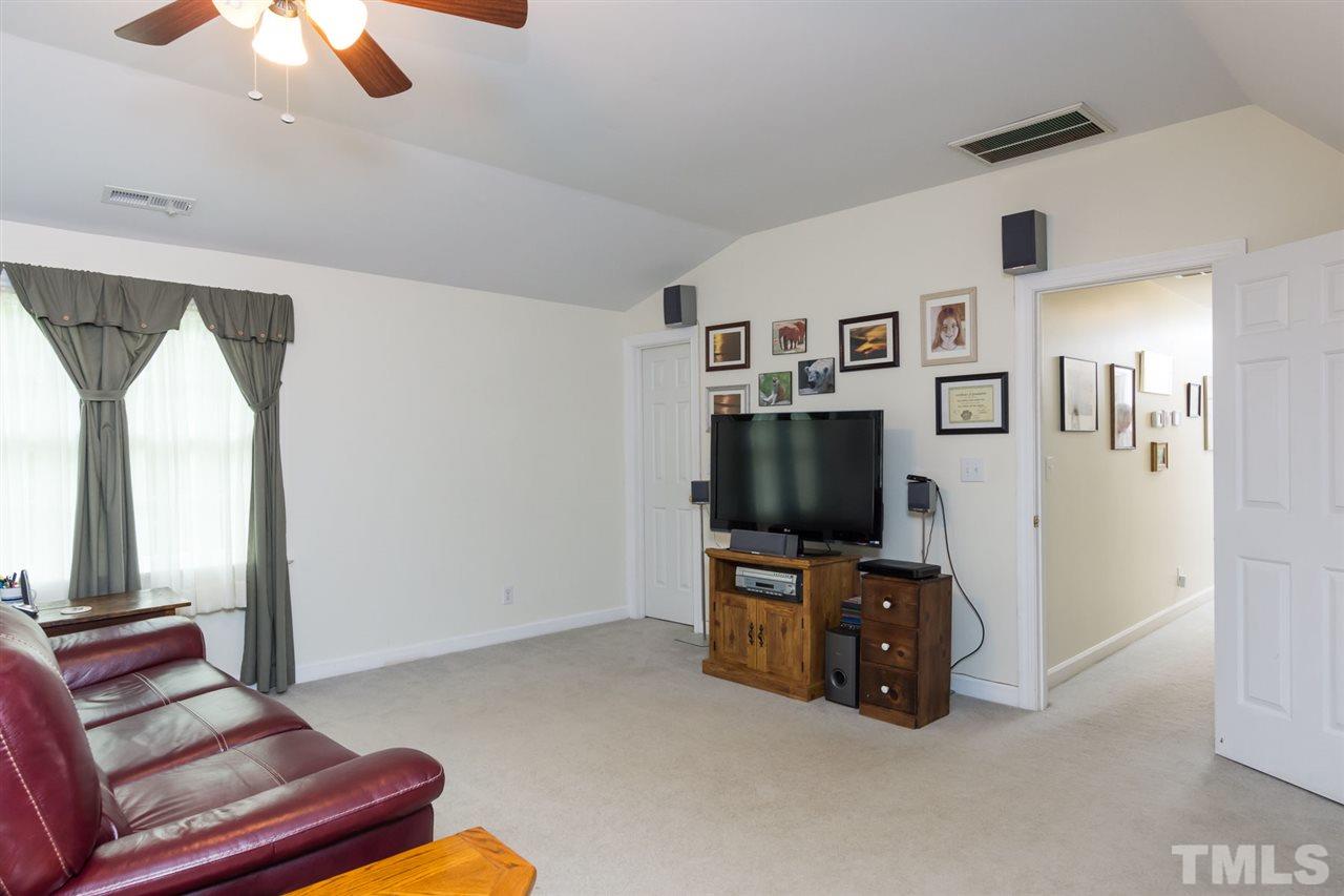 6104 Hampton Ridge Road Raleigh, NC 27603 - Photo 14 of 23 a living room with furniture and a flat screen tv