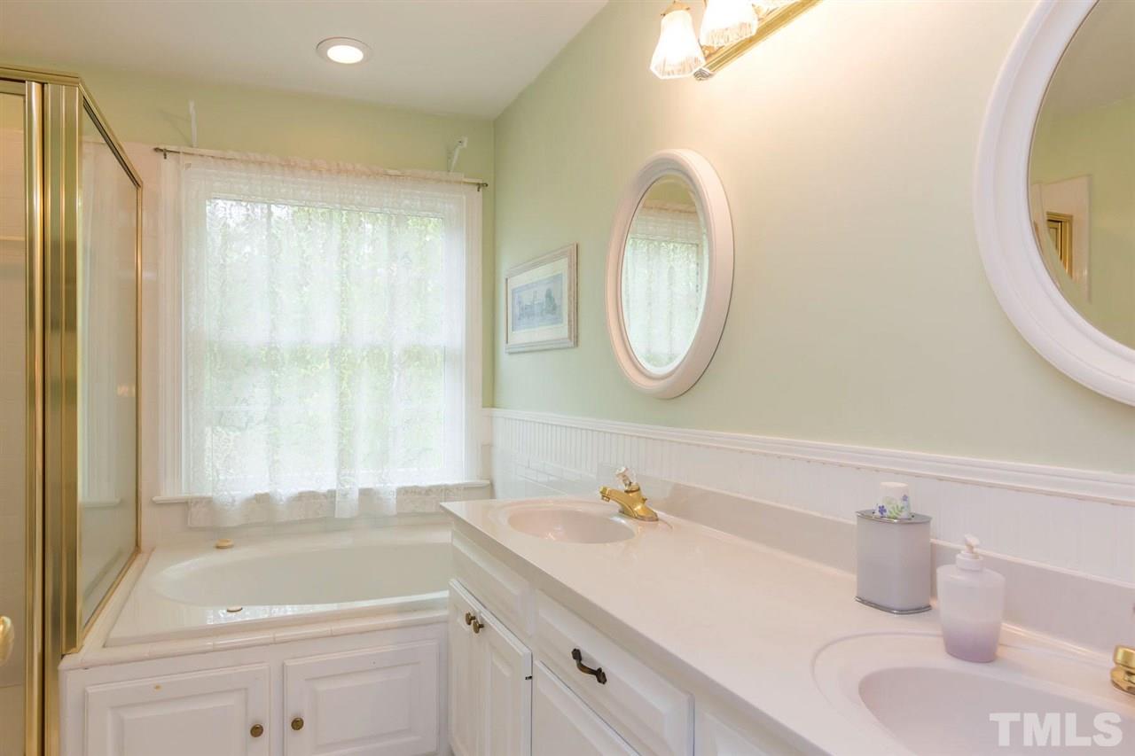 6104 Hampton Ridge Road Raleigh, NC 27603 - Photo 17 of 23 a bathroom with a sink and a mirror