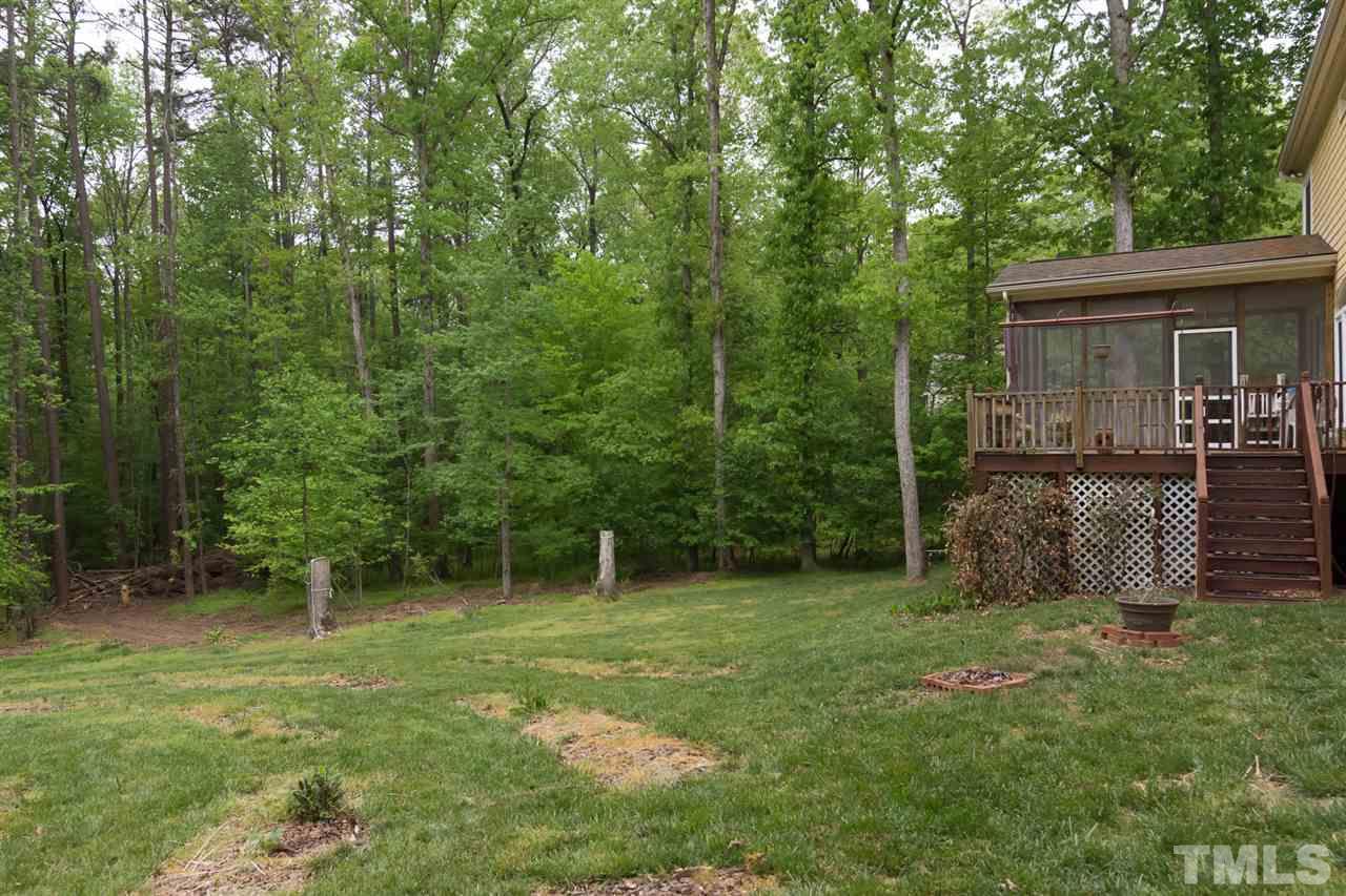6104 Hampton Ridge Road Raleigh, NC 27603 - Photo 19 of 23 a view of a backyard with a plants and trees