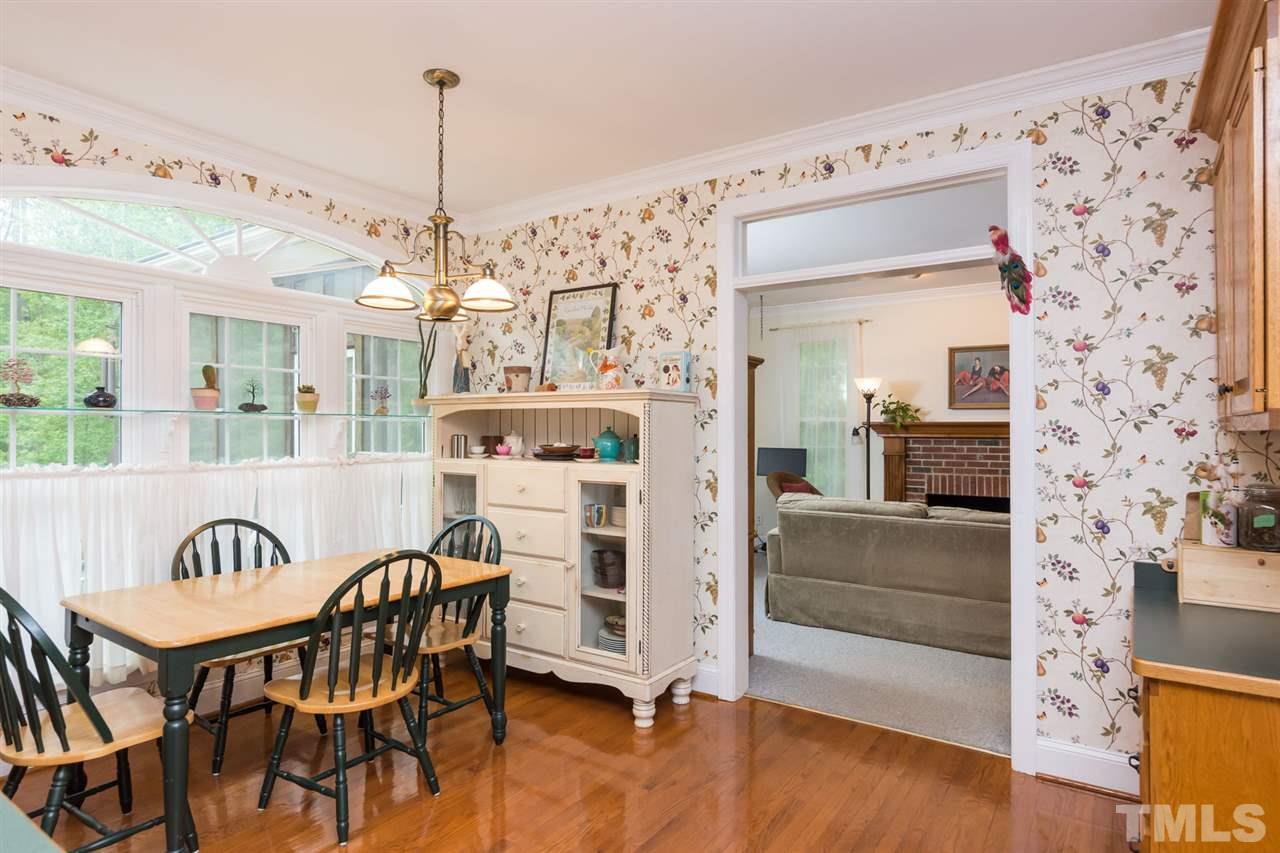 6104 Hampton Ridge Road Raleigh, NC 27603 - Photo 6 of 23 a view of a dining room and livingroom with furniture wooden floor a chandelier