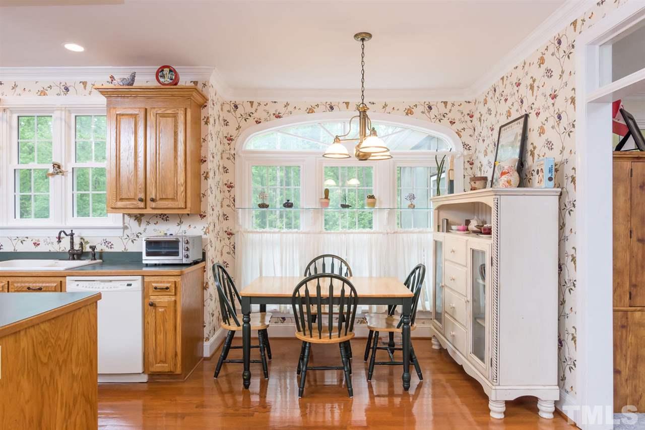 6104 Hampton Ridge Road Raleigh, NC 27603 - Photo 7 of 23 a view of a dining room with furniture window and wooden floor