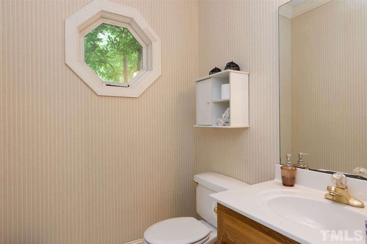 6104 Hampton Ridge Road Raleigh, NC 27603 - Photo 8 of 23 a bathroom with a toilet sink and mirror