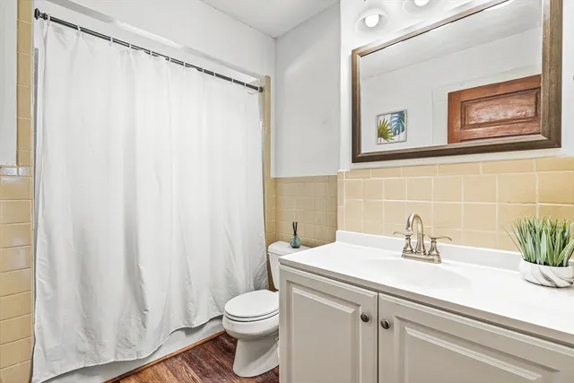 a bathroom with a sink a toilet and a mirror