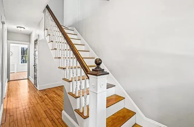 a view of entryway and hall with wooden floor