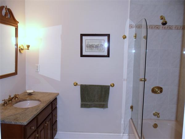 12 Boyce Farm Road Lincoln, MA 01773 - Photo 19 of 30 a bathroom with a granite countertop sink a mirror a shower and vanity