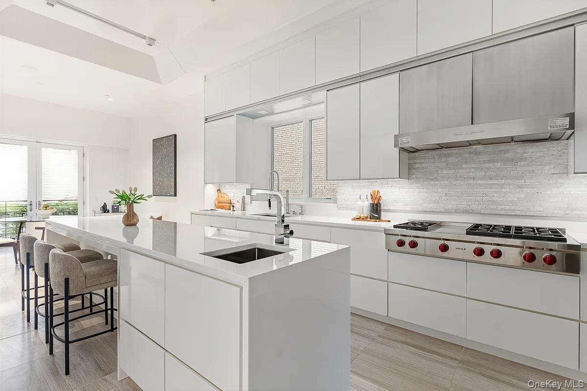 135 East 38th Street Manhattan, NY 10016 - Photo 8 of 33 a kitchen with white cabinets and appliances