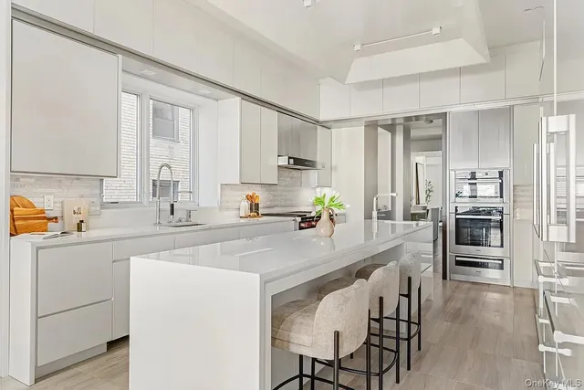 a kitchen with appliances a sink and cabinets