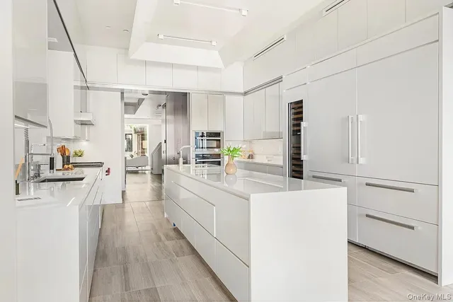 a kitchen with appliances a sink and cabinets