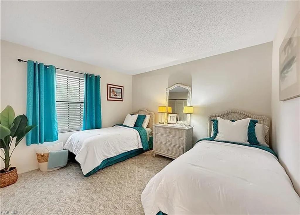 905 Augusta Boulevard Naples, FL 34113 - Photo 13 of 20 a bedroom with two beds and potted plant with two window