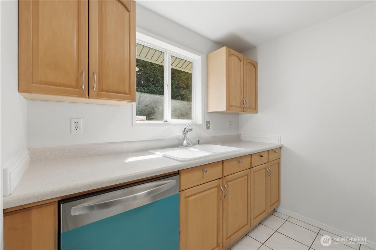 25530 150th Place Southeast Covington, WA 98042 - Photo 6 of 23 a kitchen with a sink and cabinets