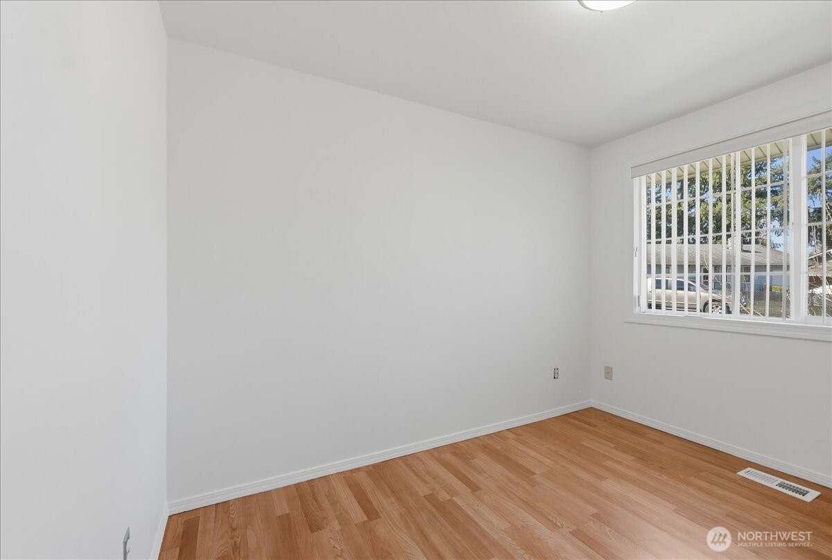 25530 150th Place Southeast Covington, WA 98042 - Photo 8 of 23 a view of an empty room with wooden floor and a window