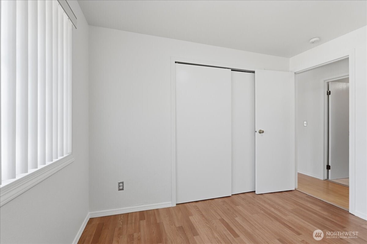 25530 150th Place Southeast Covington, WA 98042 - Photo 9 of 23 a view of an empty room with wooden floor and a window