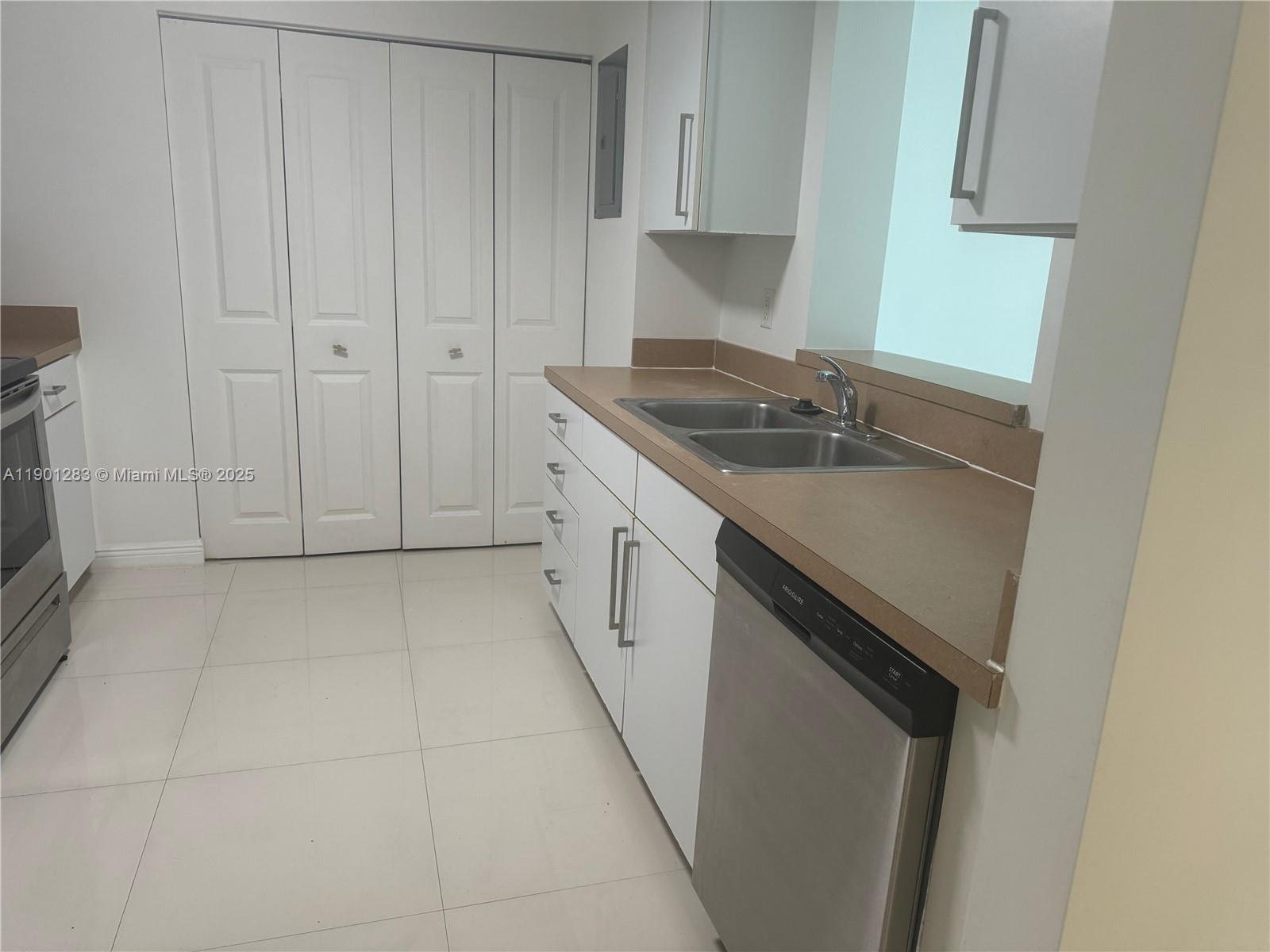 1250 South Miami Avenue, Unit 1404 Miami, FL 33130 - Photo 4 of 8 a kitchen with a sink and cabinets