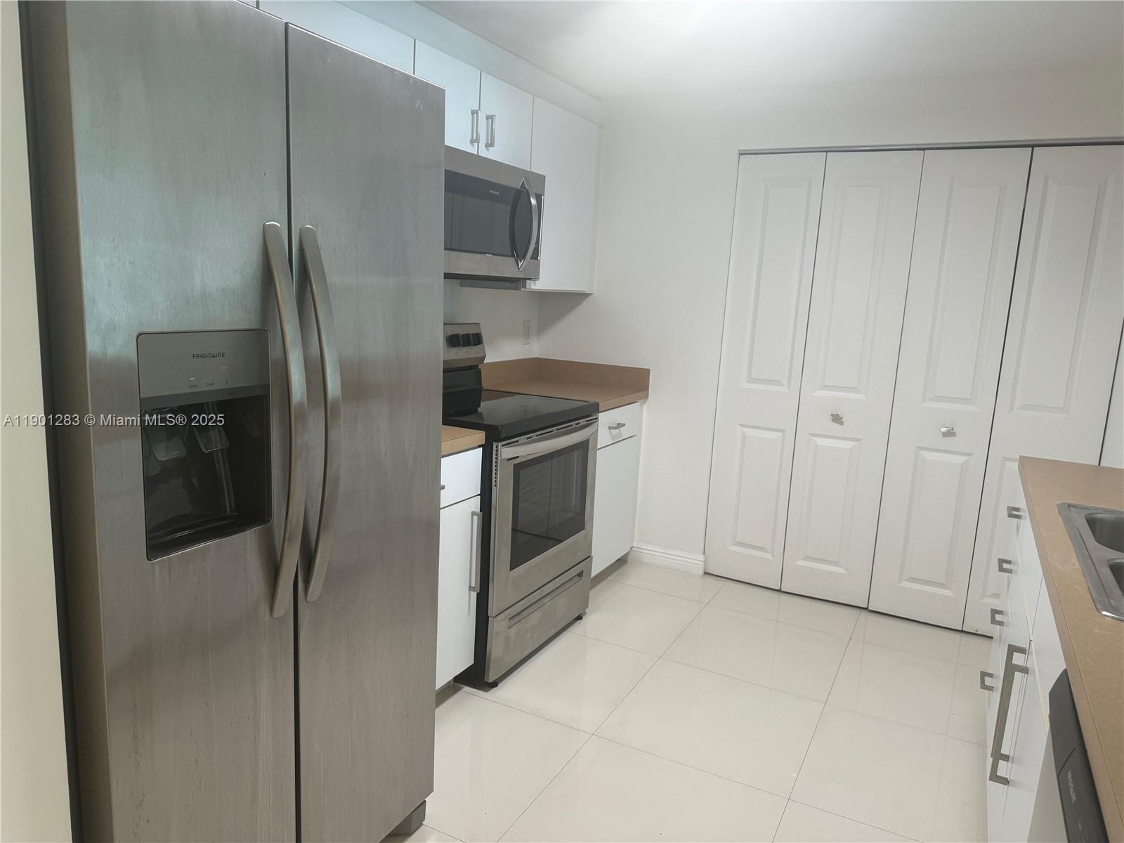 1250 South Miami Avenue, Unit 1404 Miami, FL 33130 - Photo 6 of 8 a kitchen with stainless steel appliances granite countertop a refrigerator and a stove