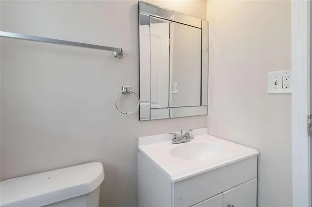 a bathroom with a sink vanity and a shower