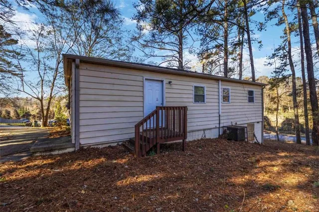 a backyard of a house with table and chairs