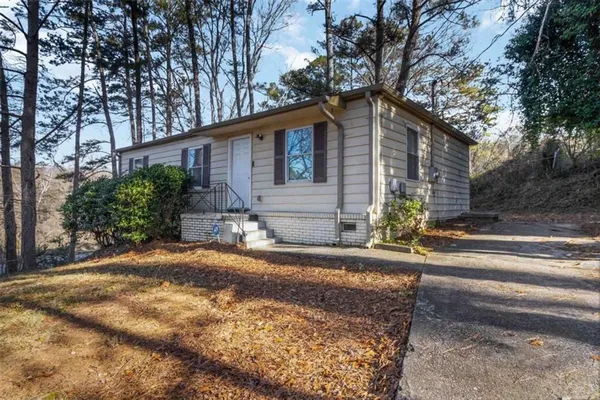 a house that has a tree in front of it