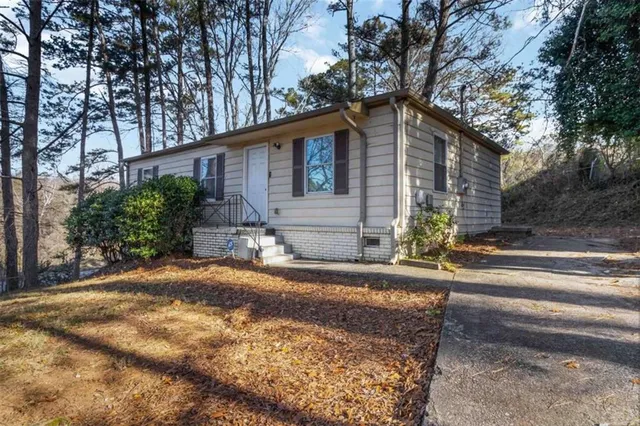 a house that has a tree in front of it