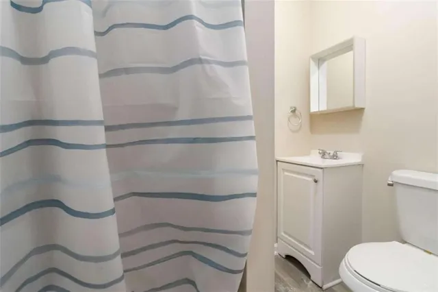a bathroom with a toilet and a shower