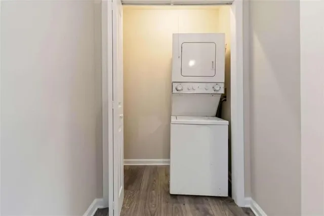 a utility room with wooden floor washer and dryer