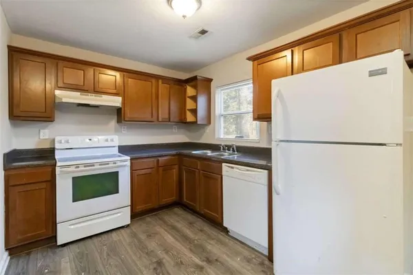 a kitchen with a refrigerator sink and stove