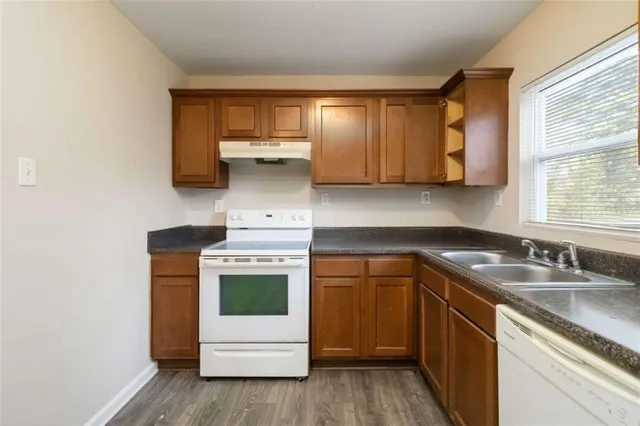 a kitchen with a sink stove and cabinets