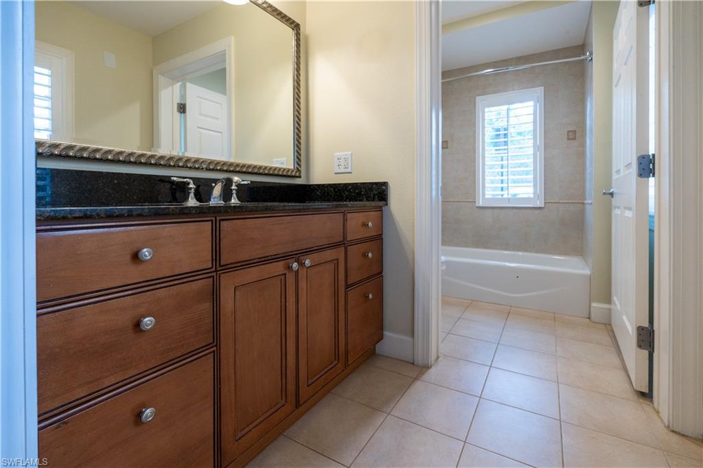 1362 Centre Ct Ridge Drive, Unit 101 Reunion, FL 34747 - Photo 12 of 25 Bathroom with tile floors, tiled shower / bath, and oversized vanity