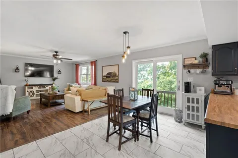 a living room with fireplace furniture and a flat screen tv