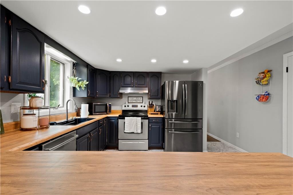 555 Hiawatha Road Prosperity, PA 15329 - Photo 12 of 40 a kitchen with stainless steel appliances granite countertop a refrigerator and a sink