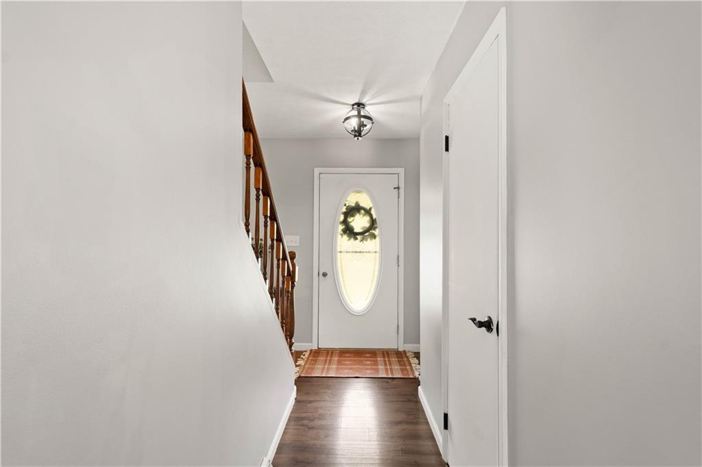 555 Hiawatha Road Prosperity, PA 15329 - Photo 17 of 40 a view of a hallway with wooden floor and staircase