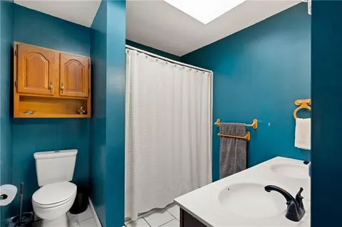 a bathroom with a toilet sink and mirror