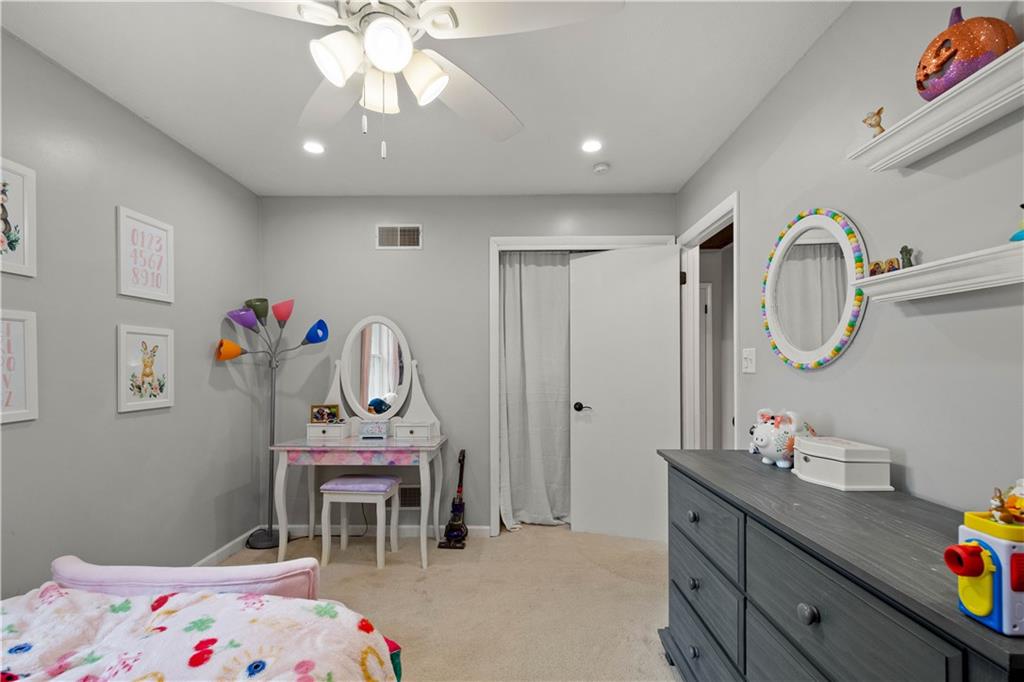 555 Hiawatha Road Prosperity, PA 15329 - Photo 25 of 40 a bedroom with a bed a dresser and a chandelier