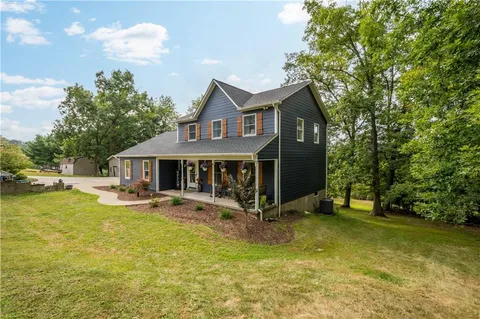 a front view of a house with a yard table and chairs