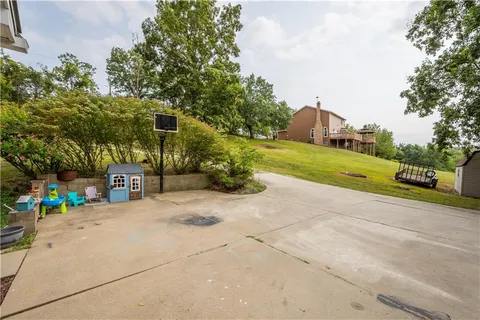 a view of a street with a building and a street sign