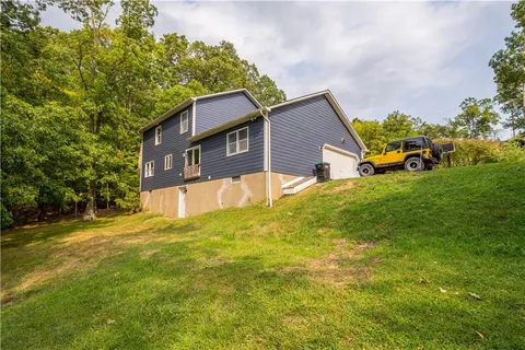 a view of a house with a yard and garage