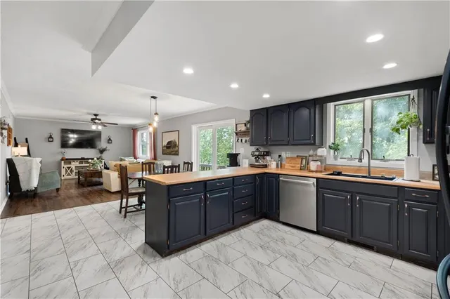a large kitchen with lots of counter and chairs