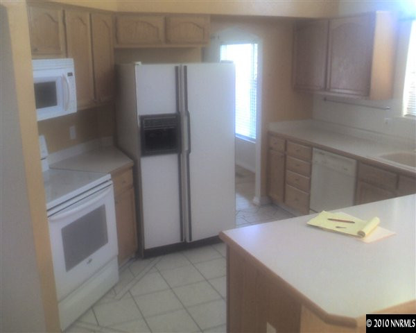 6319 Chesterfield Lane Reno, NV 89523 - Photo 3 of 8 a kitchen with stainless steel appliances a refrigerator and a stove