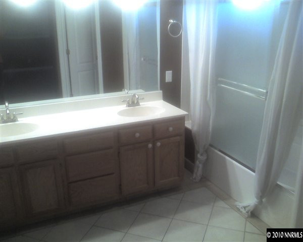 6319 Chesterfield Lane Reno, NV 89523 - Photo 7 of 8 a bathroom with a sink and mirror