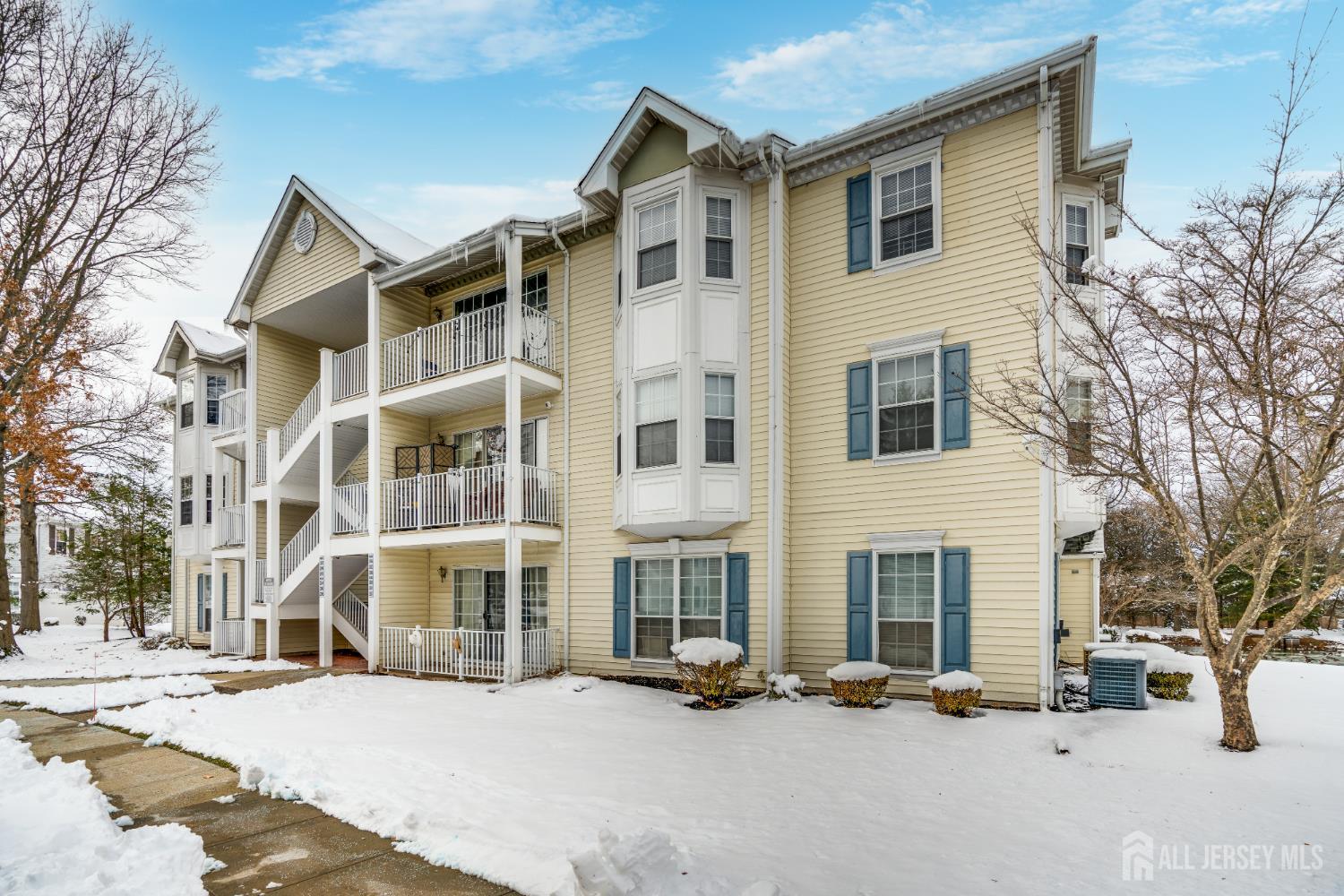 304 Wimbeldon Court North Brunswick, NJ 08902 - Photo 13 of 19 a view of a building with a snow on the road