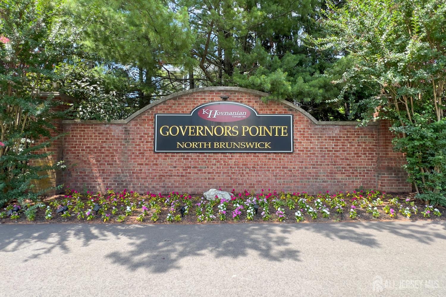 304 Wimbeldon Court North Brunswick, NJ 08902 - Photo 19 of 19 a sign that is sitting in front of flowers