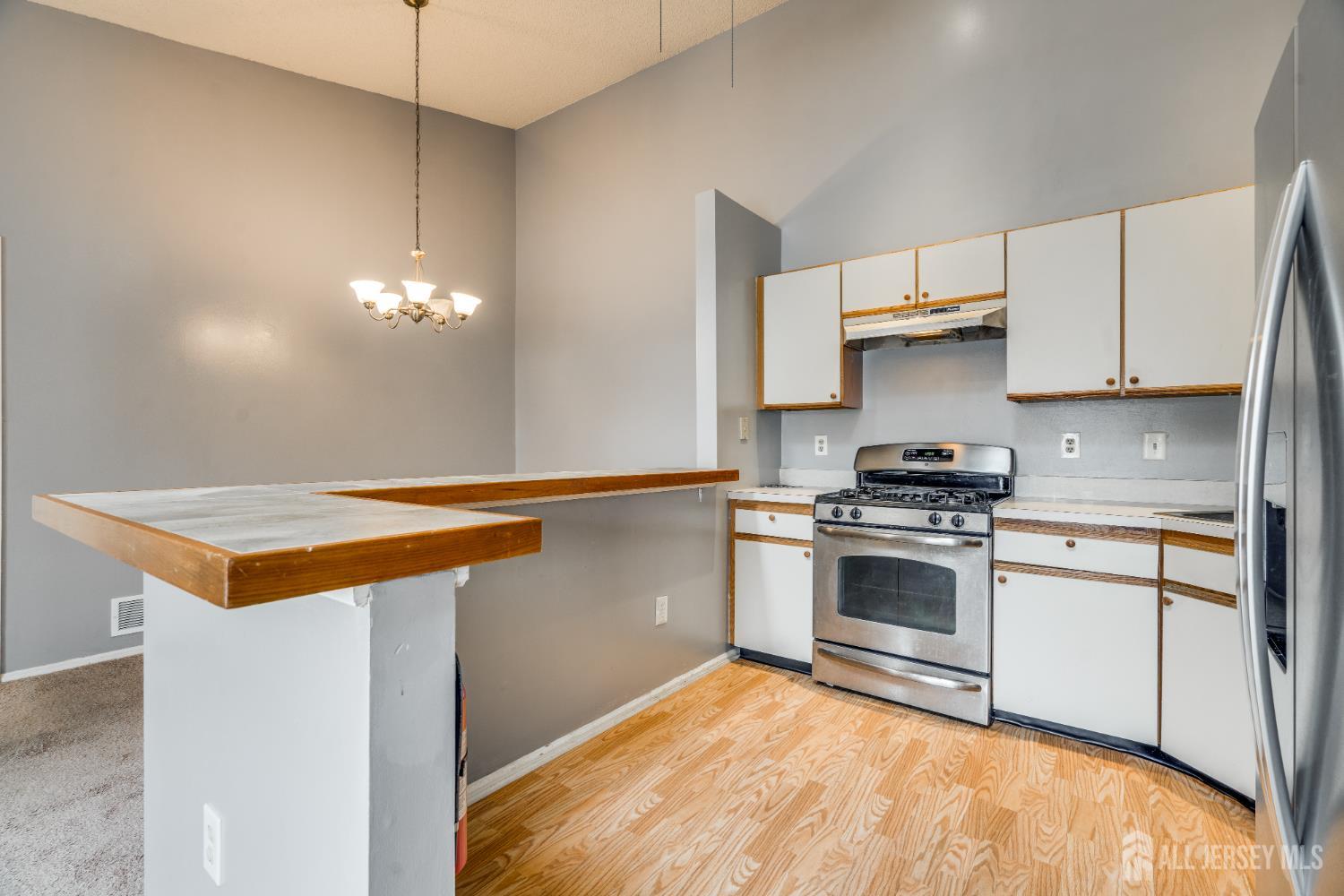 304 Wimbeldon Court North Brunswick, NJ 08902 - Photo 4 of 19 a kitchen with stainless steel appliances a stove a sink and a refrigerator