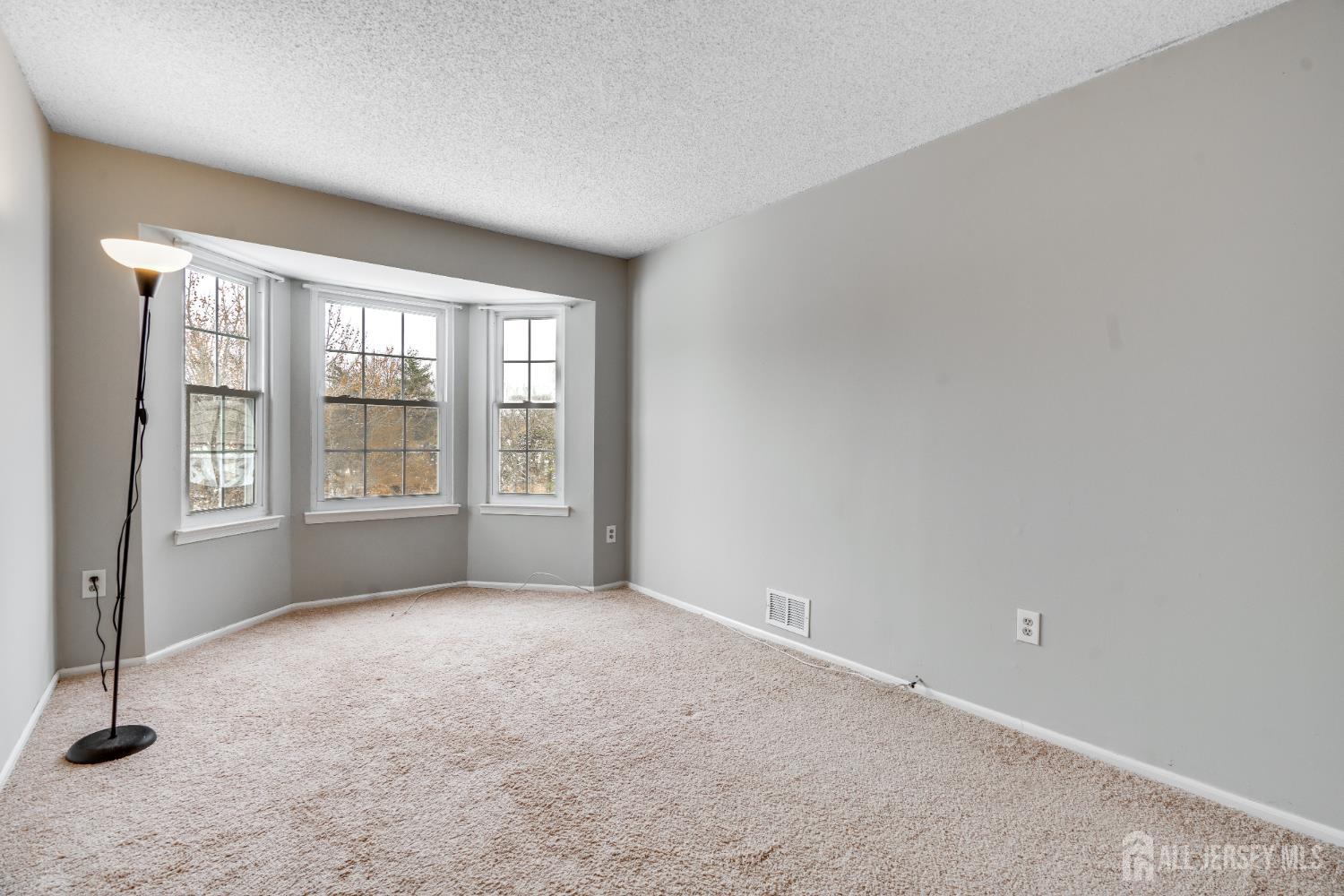 304 Wimbeldon Court North Brunswick, NJ 08902 - Photo 6 of 19 a view of an empty room with a window