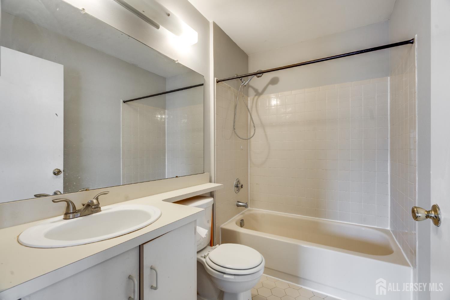 304 Wimbeldon Court North Brunswick, NJ 08902 - Photo 8 of 19 a bathroom with a sink mirror toilet and bathtub