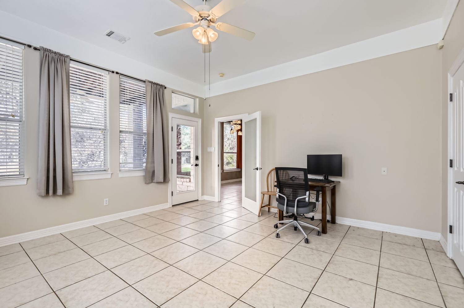 210 Amandas Way Leander, TX 78641 - Photo 18 of 38 Office space with a ceiling fan, a healthy amount of sunlight, visible vents, and light tile patterned floors